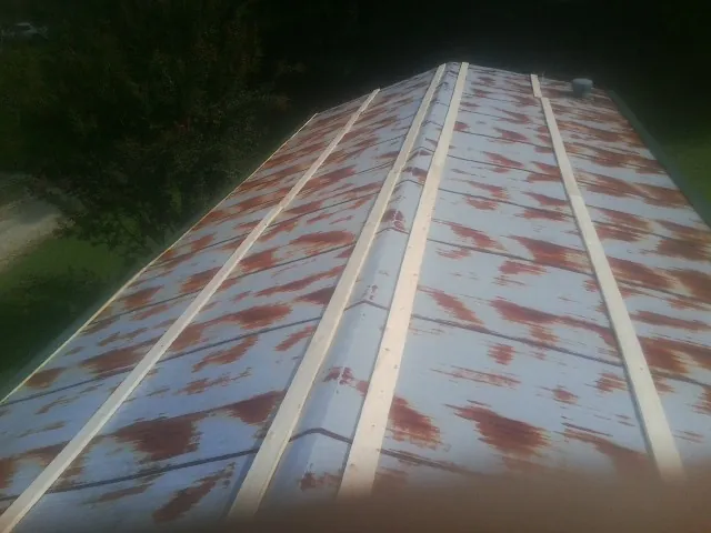 Rusted metal roof panels with new wood purlins before replacement — Storm Damage Roof Repair in Gloucester City by Roofing Brothers