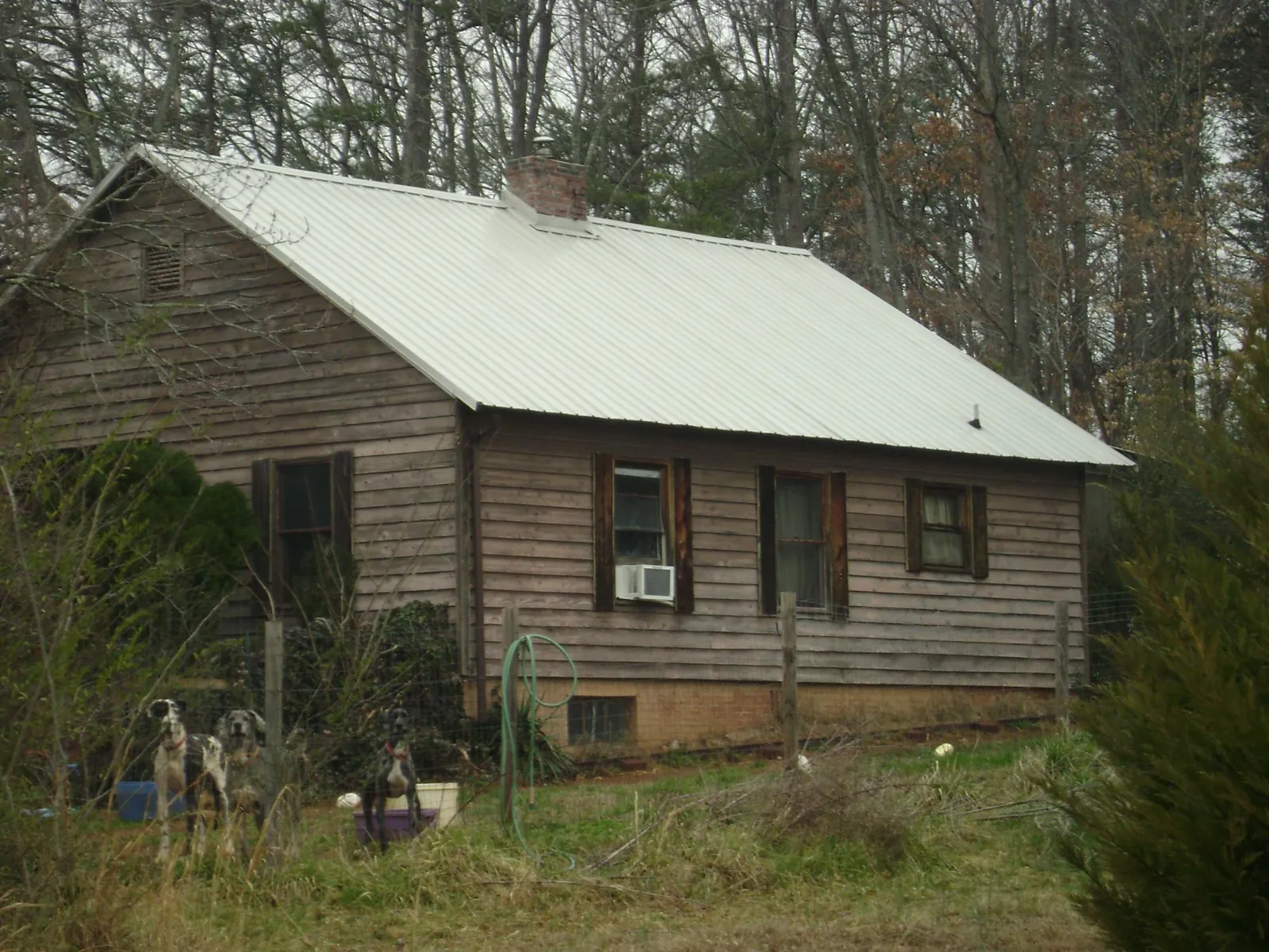 White metal roof on an old wood sided farmhouse, from a Metal Roof Installation job in Gloucester City
